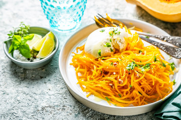 Butternut squash noodles with mozzarela, pecans, herbs, copy space