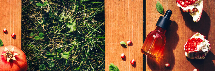 Pomegranate seed oil, serum in glass bottle on wooden background. Flat lay