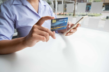 Business woman consumer holding credit card and smartphone for online shopping and payment make a purchase on the Internet