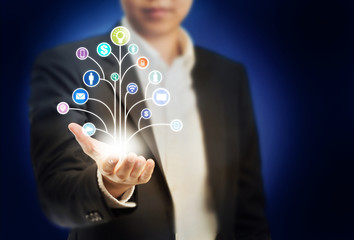 Grow your social network growing your business strategy concept, Business man holding graphic icons graph network tree in hand