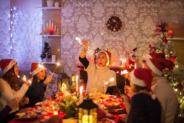 Little daughter playing with hand fireworks for christmas celebration