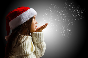 winter time! Happy little girl blowing on snow