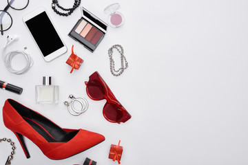 top view of gadget, gift boxes, perfume, bracelets, decorative cosmetics, earrings, earphones, shoes