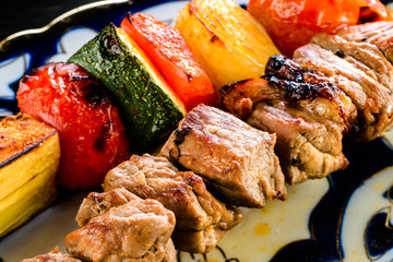 grilled lamb and vegetables kebab close-up