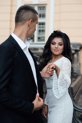 Loving couple hold hands. Wedding ring. Offer to marry. Love people. Boy and girl. Love story. Romance. The girl is happy. Beautiful woman with professional make up and hair style.