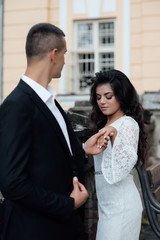 Loving couple hold hands. Wedding ring. Offer to marry. Love people. Boy and girl. Love story. Romance. The girl is happy. Beautiful woman with professional make up and hair style.
