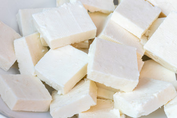 Paneer or cottage cheese cube close up, slice pieces of homemade fresh raw panner.