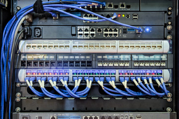 Back I/O port of server rack and blue cable connected to LAN port for work on networking communication on DATA Center information, computer and networking technology for work on internet worldwide