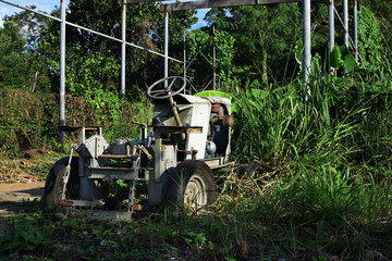 Wasted dilapidated rustic old farm tractor left on the vicinity of agricultural college campus