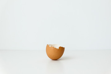 half broken brown egg isolated on white background