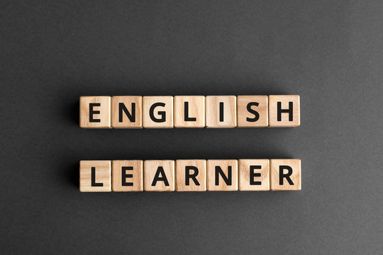 English learner - phrase from wooden blocks with letters, student  english learner concept, top view gray background
