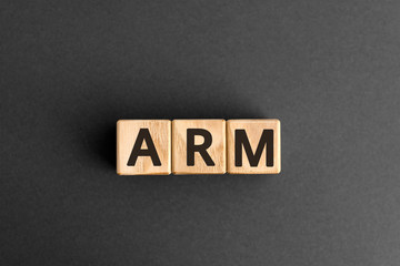 ARM - acronym from wooden blocks with letters, Advanced RISC Machine ARM concept chip architectures microprocessor technology,  top view on grey background