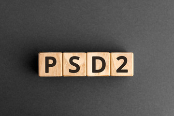 PSD2 - acronym from wooden blocks with letters, Payment Service Directive 2 PSD2 online payment and ecommerce concept,  top view on grey background