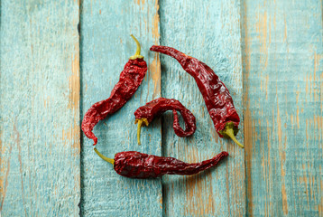 Dried red chilli peppers on old wooden background. Healthy eating concept.