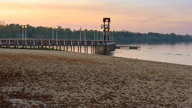 Autumn view of beach and pier at Pogoria III lake