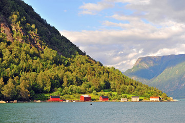 Beautiful houses on lake with mountains on background