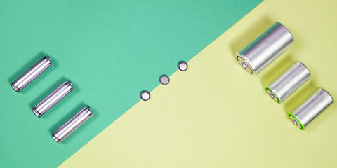 Many different types used or new battery, rechargeable accumulator, alkaline batteries on color...