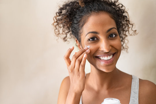 Beautiful Girl Applying Face Cream