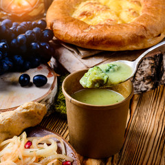 Vegetarian food. cream soup with broccoli in a spoon close-up
