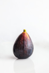 one ripe figs on a white background close-up