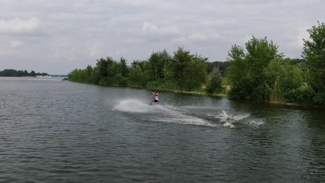 High jump of a wakeboarder, release stunt, aerial footage, water sport