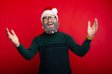 Fototapeta premium Photo of cheerful man with decorated beard ready for holidays