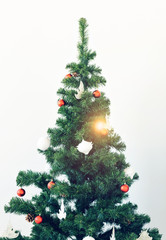 Holidays and celebration concept - Decorated Christmas tree on white background