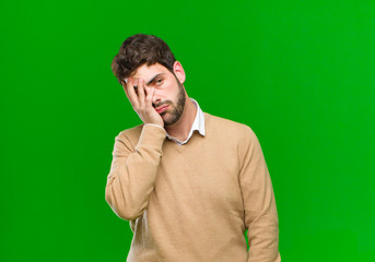 young businessman feeling bored, frustrated and sleepy after a tiresome, dull and tedious task,...