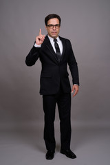 Obraz na płótnie Canvas Full body shot of handsome Persian businessman in suit