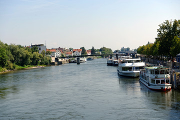 Fototapeta na wymiar River Danube tour boats docked at Regensburg in Bavaria, Germany