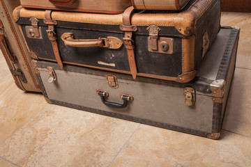 Old, retro, suitcases lie on the table with white background