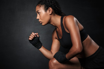 Image of african american woman in sportswear and hand wraps running - Powered by Adobe