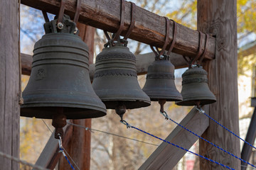 Fototapeta premium Four distant bronze church bells of different sizes
