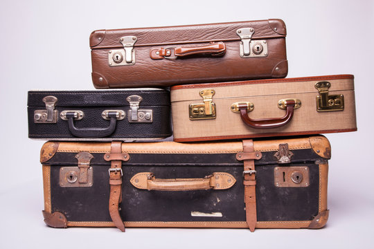 Old, retro, suitcases lie on the table with white background © fotogeng