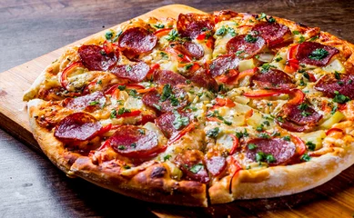 Foto op Canvas Pepperoni Pizza with Mozzarella cheese, salami, pepper. Spices and Fresh basil. Italian pizza on wooden table background © pavel siamionov