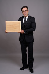 Full body shot of handsome Persian businessman in suit