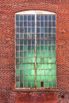 veertical background of an industrial factory window set in a brick wall