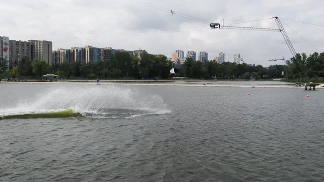 Release stunt, wakeboarder is jumping and spinning in the air doing back roll