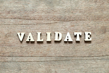 Letter block in word validate on wood background