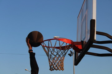 basketball hoop and net against blue sky