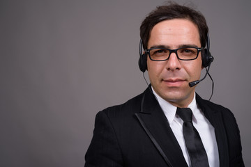 Handsome Persian businessman working as call center representati