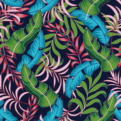 Tropical seamless summer pattern with bright blue and green leaves and plants on a blue background.   Vector design. Jungle print. Floral background.  Exotic tropics. Summer.