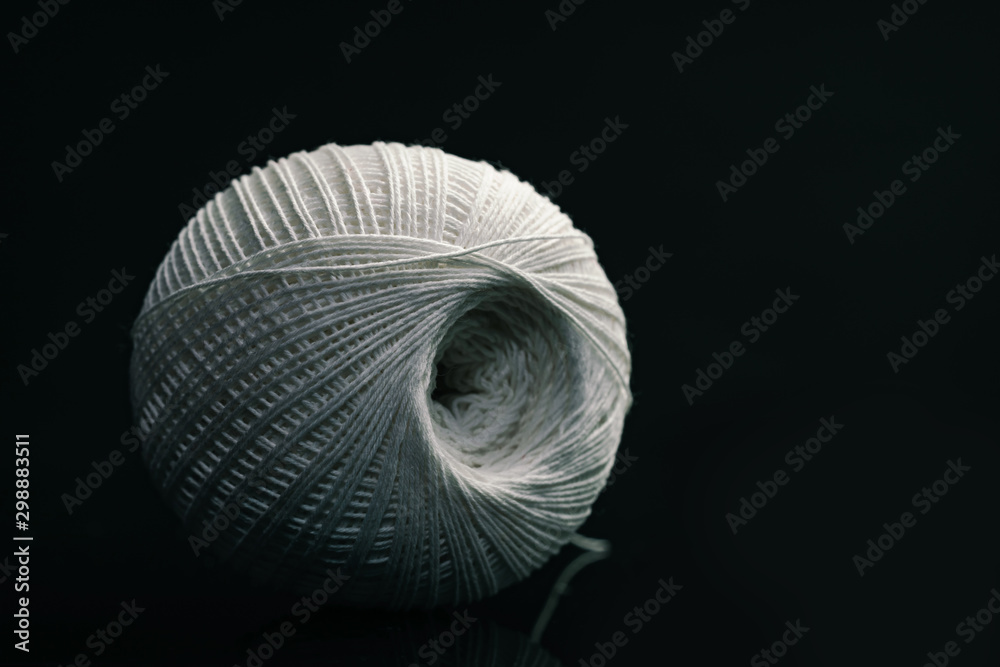 Poster beautiful white tangle of thread on a dark background texture.