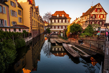 Beautiful sunset view in Petite Venice with water canal and traditional half timbered houses, Colmar, Alsace, France