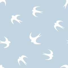 Obraz na płótnie Canvas Seamless pattern with white silhouettes of swallows on blue background. Vector illustration.