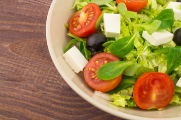 Fresh greek salad with tomatoes olives fetax herbs, close-up. Mix Of Vegetables, Mediterranean Cuisine