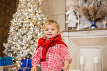 Joyful kid looking at camera in christmas. Winter holidays. Celebration.