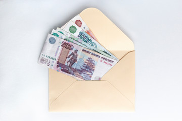 Banknotes of rubles, cash money in envelope on white background. Money savings concept.