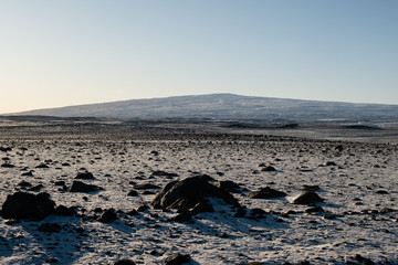 Landscape with first snow near Húsfell. In the background the mountain Ok. Formally, the mountain was covered by a glacier, the Okjökull. 