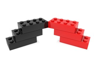 Red and black toy brick building on a white background